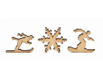 A closeup of pieces in the shape of a skier, a snowflake, and a snowboarder.