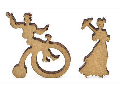 A closeup of pieces in the shape of a man riding a bicycle and a woman with a parasol.