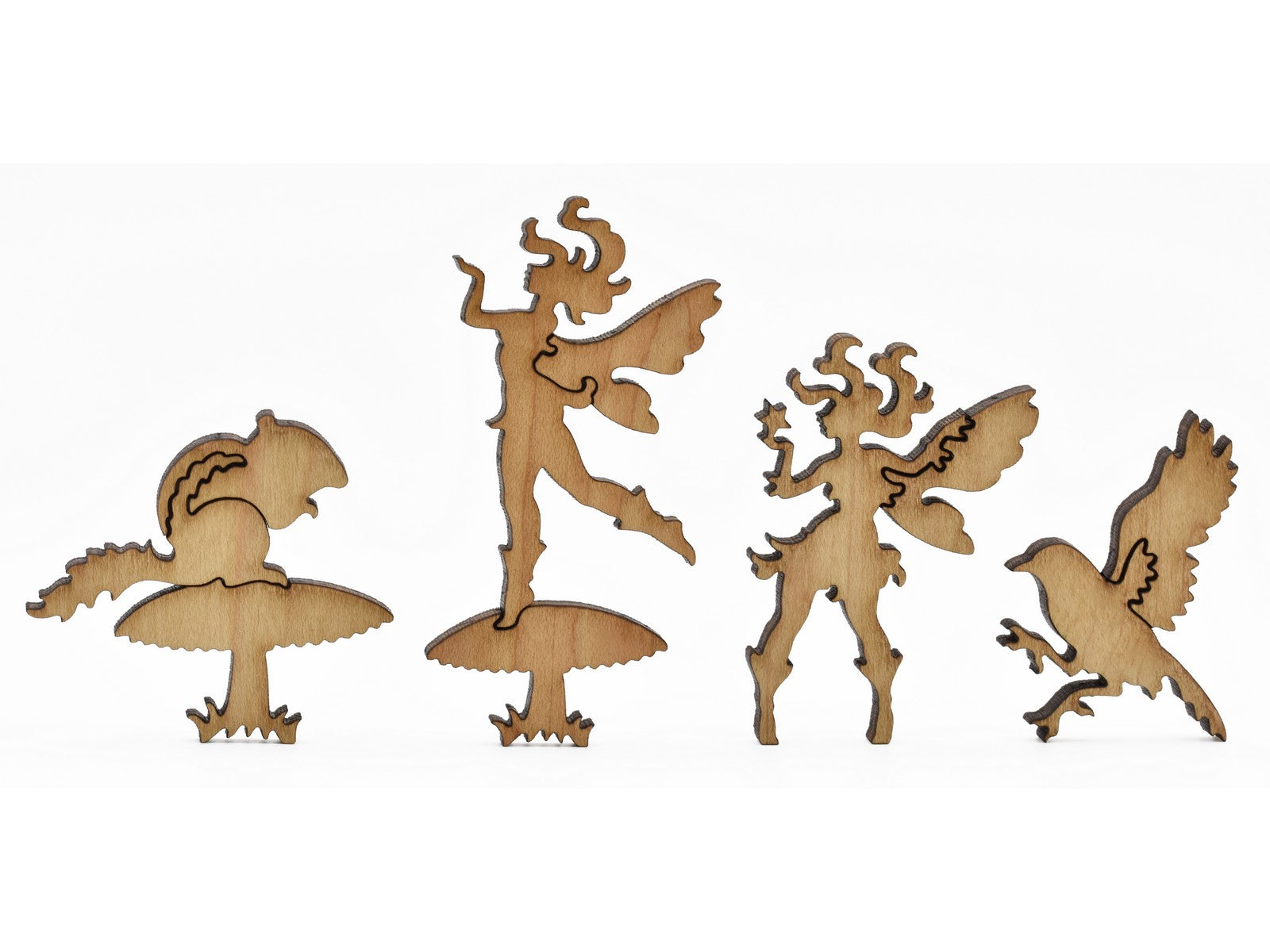 A closeup of pieces in the shape of fairies and mushrooms.