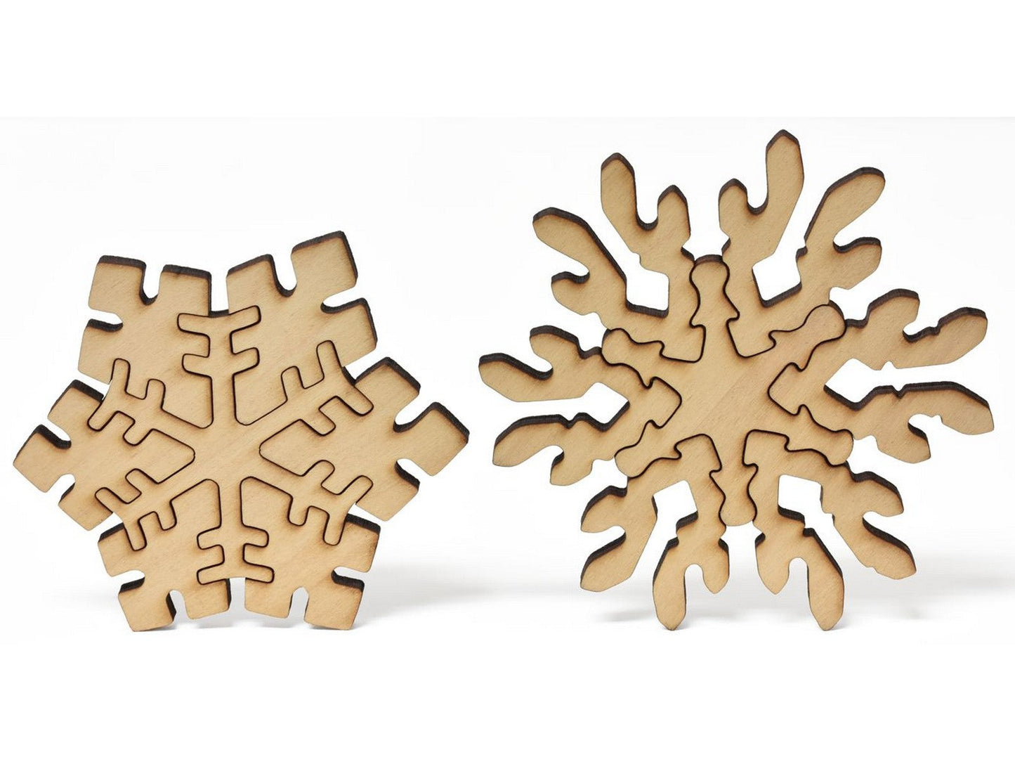 A closeup of pieces in the shape of multi-piece snowflakes.