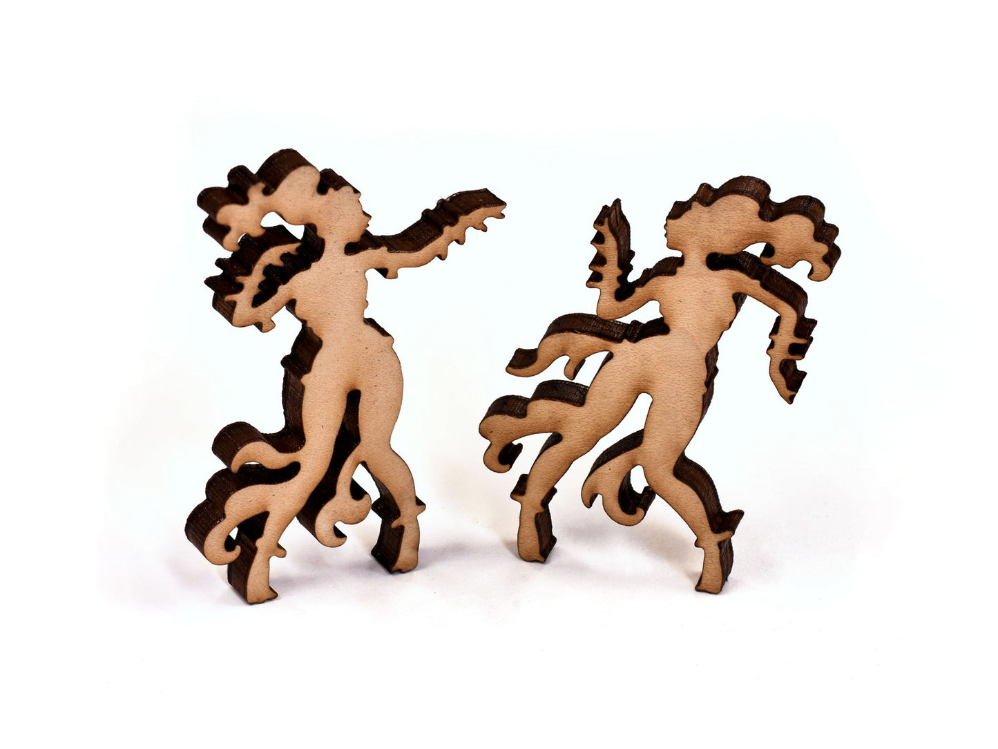 A closeup of pieces in the shape of two women dancing.
