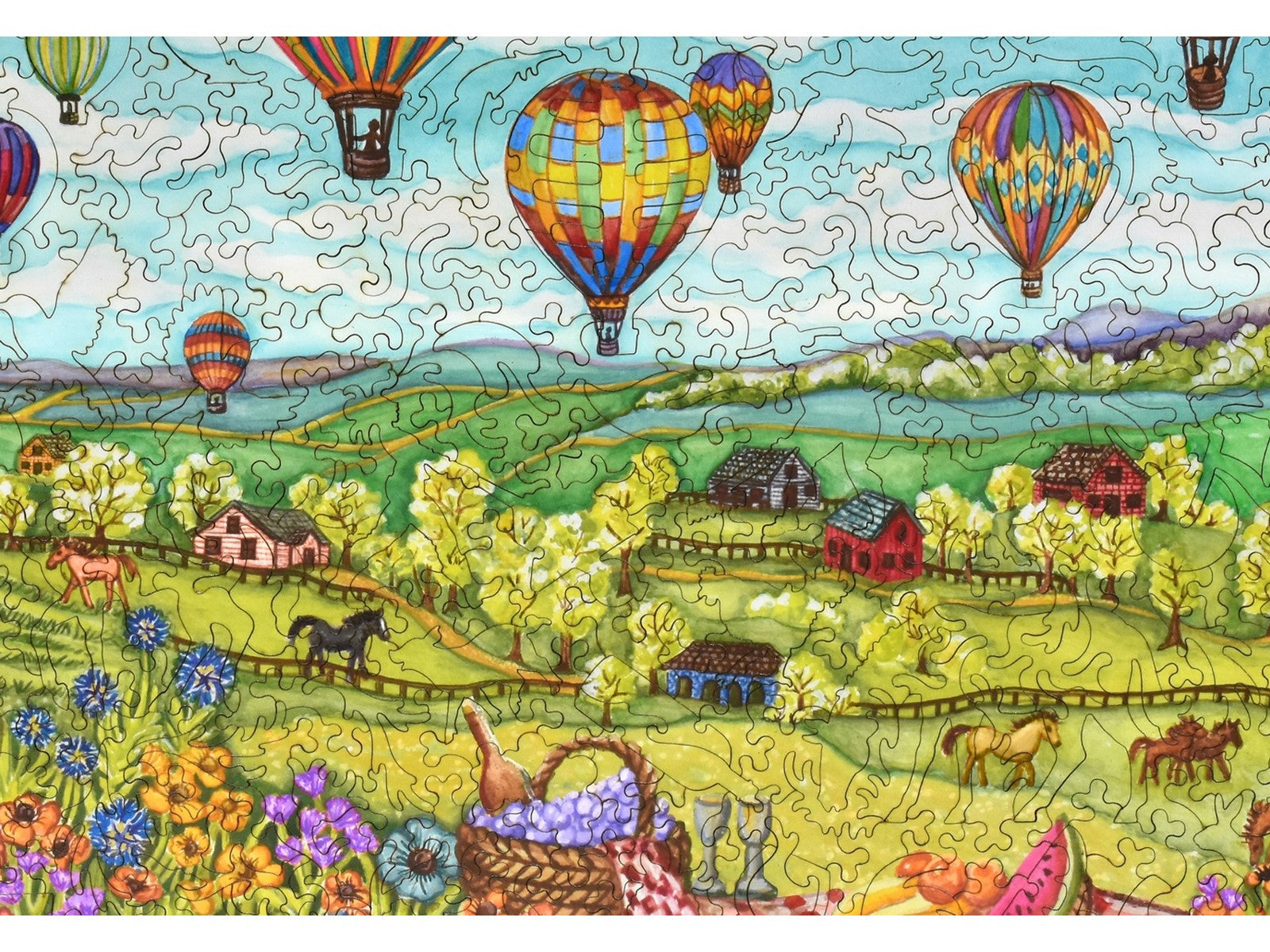 A closeup of the front of the puzzle, Balloons Over Farmland, showing the detail in the pieces.