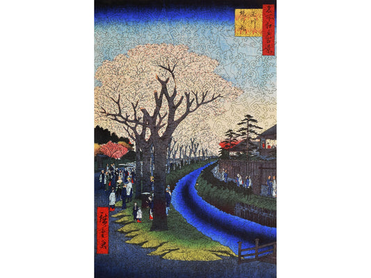 The front of the puzzle, Blossoms on the Tama River Embankment, which shows cherry trees in bloom along a small river.