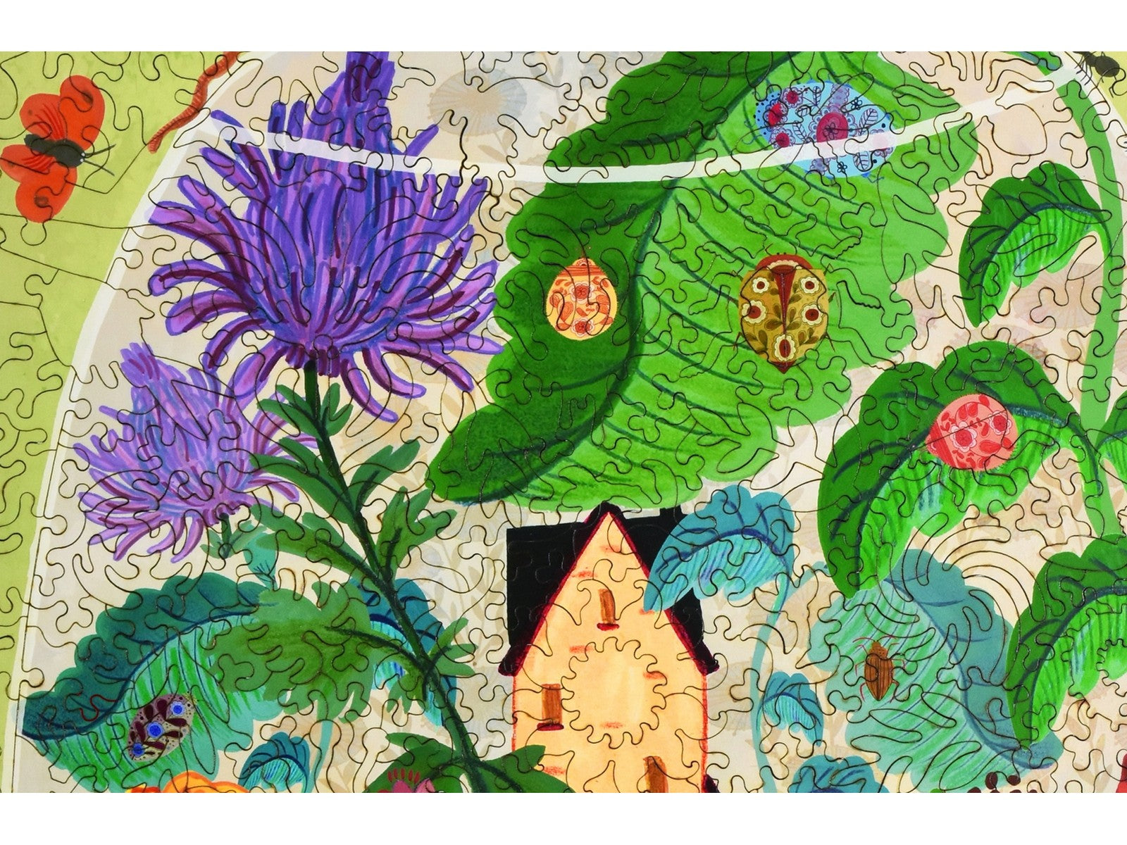 A closeup of the front of the puzzle, Bug Garden Terrarium, showing the detail in the pieces.