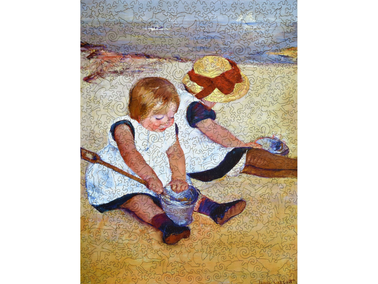 The front of the puzzle, Children Playing on the Beach, which shows two young children playing in the sand.