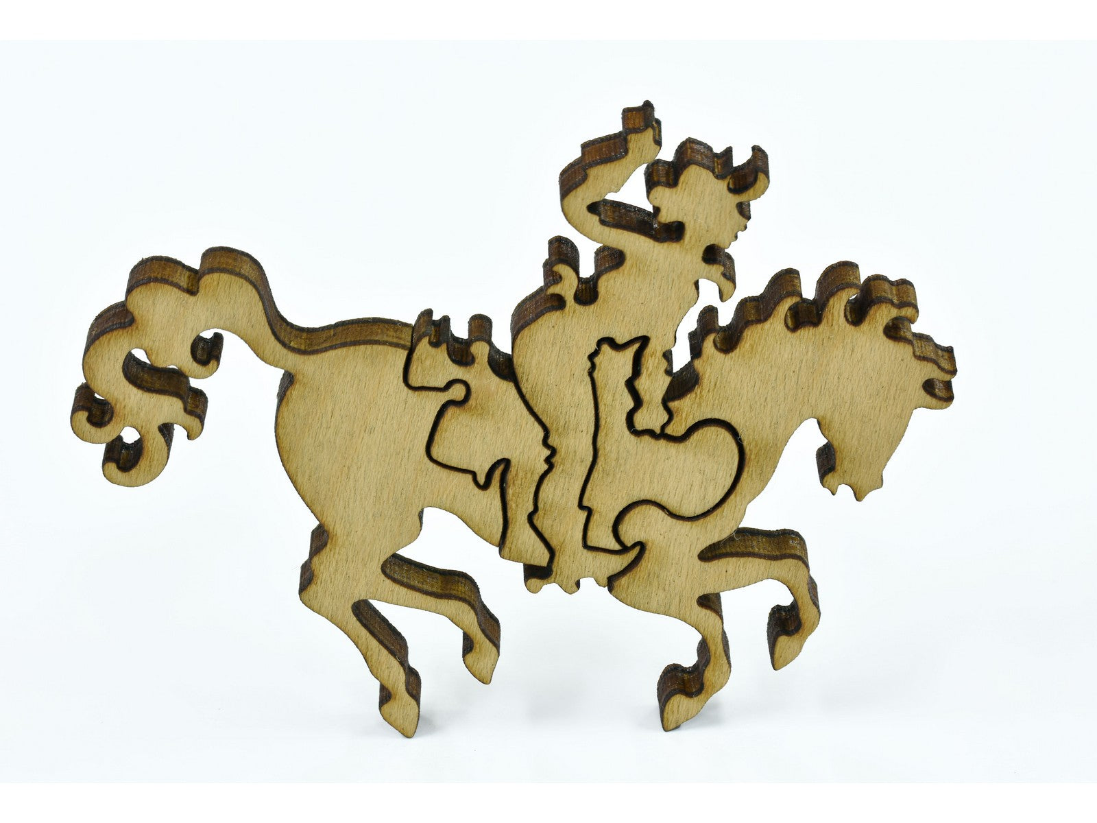 A closeup of pieces in the shape of person riding a horse.