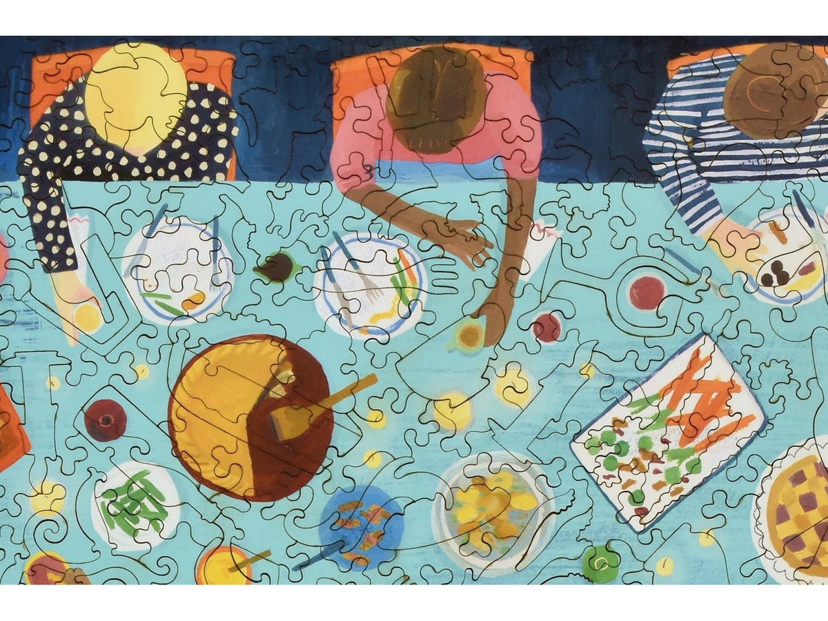 A closeup of the front of the puzzle, Dinner Party, showing the detail in the pieces.