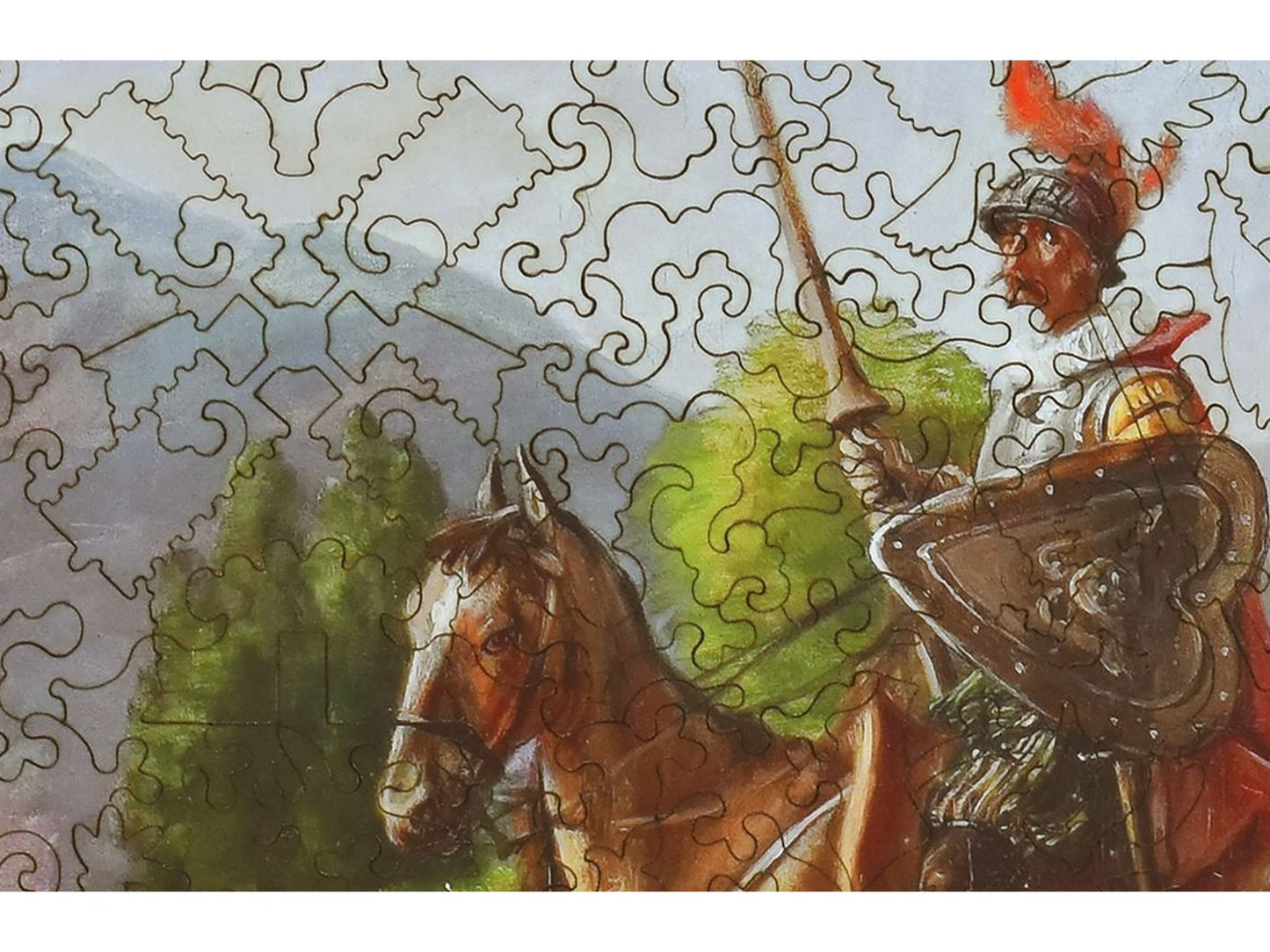 A closeup of the front of the puzzle, Don Quixote and Sancho Panza at a Crossroads, showing the detail in the pieces.