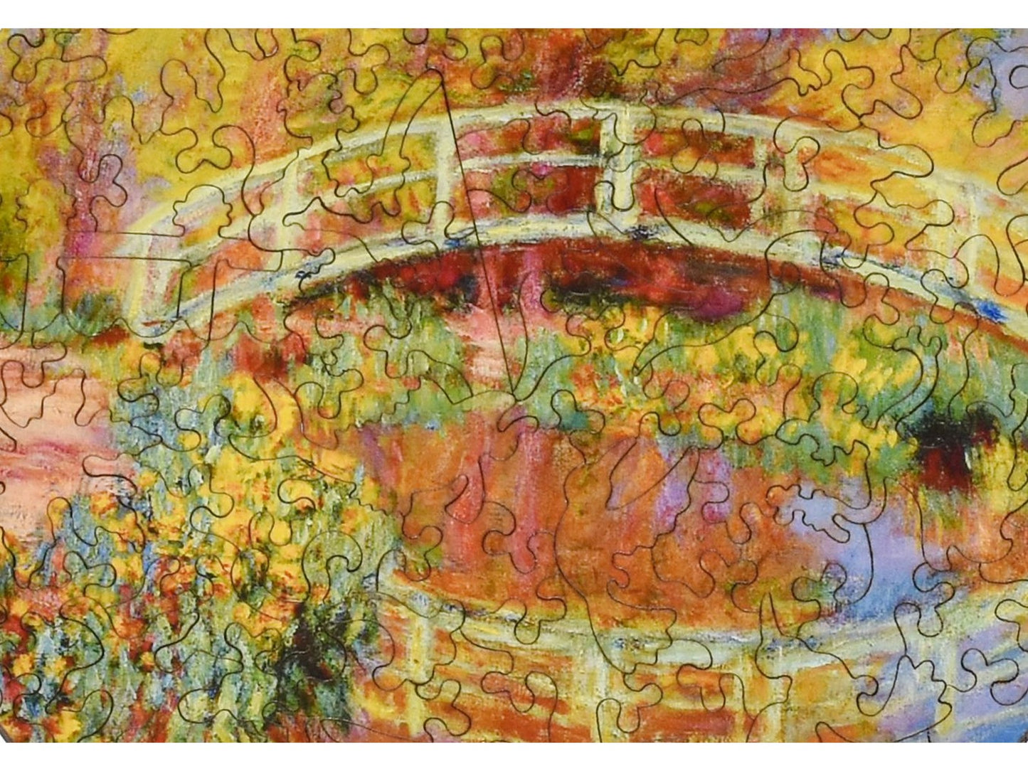 A closeup of the front of the puzzle, Japanese Bridge in Monet's Garden, showing the detail in the pieces.