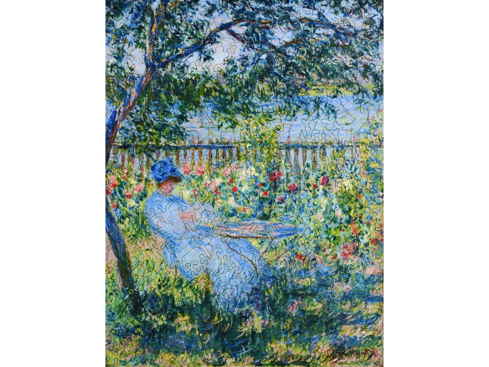 The front of the puzzle, La Terrasse, which shows a woman relaxing in a chair underneath a tree.