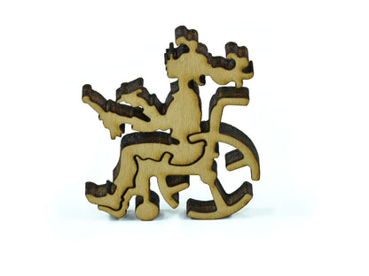 A closeup of pieces in the shape of a girl in a wheelchair.