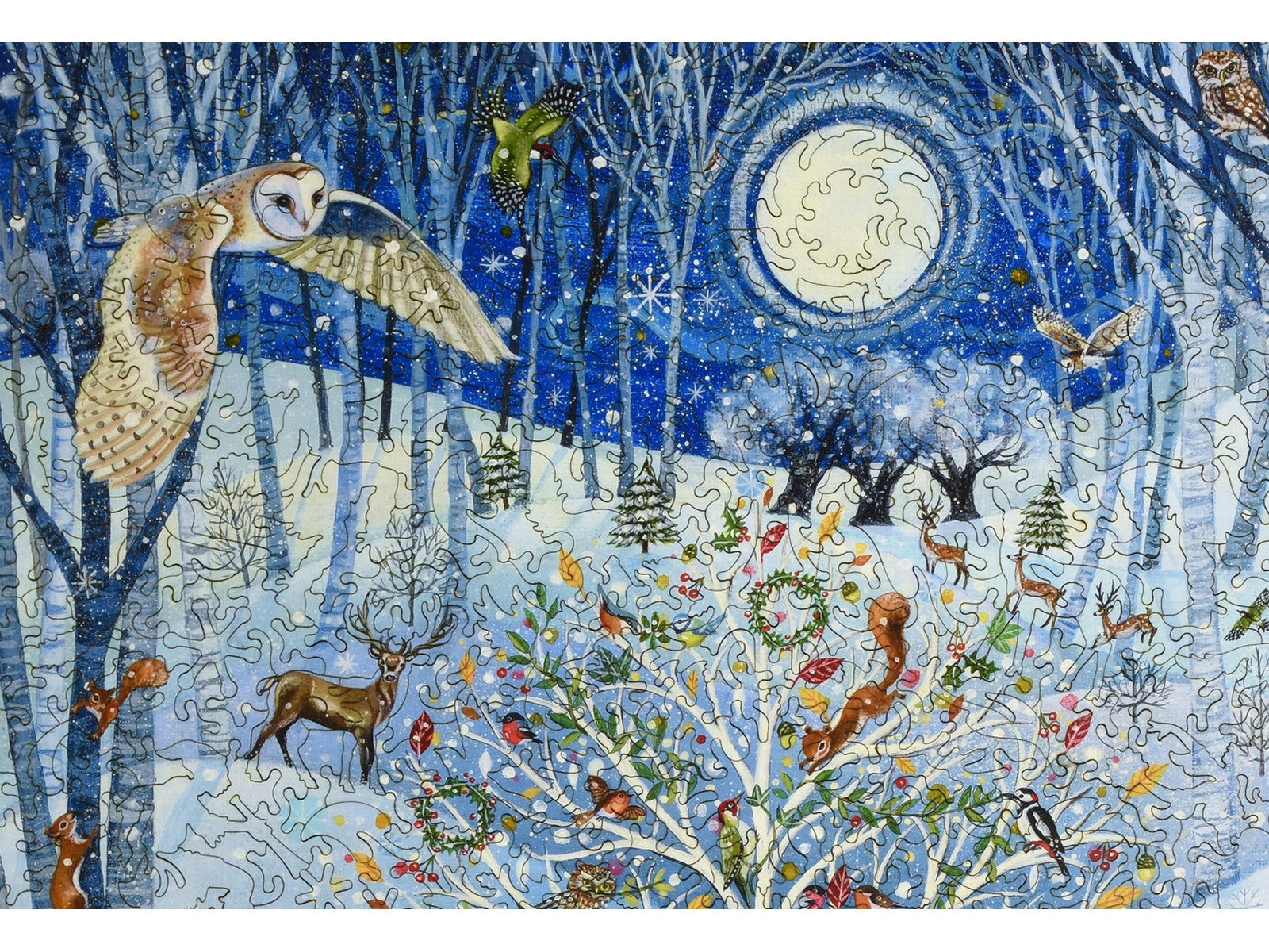 A closeup of the front of the puzzle, Magical Winter Woodland, showing the detail in the pieces.