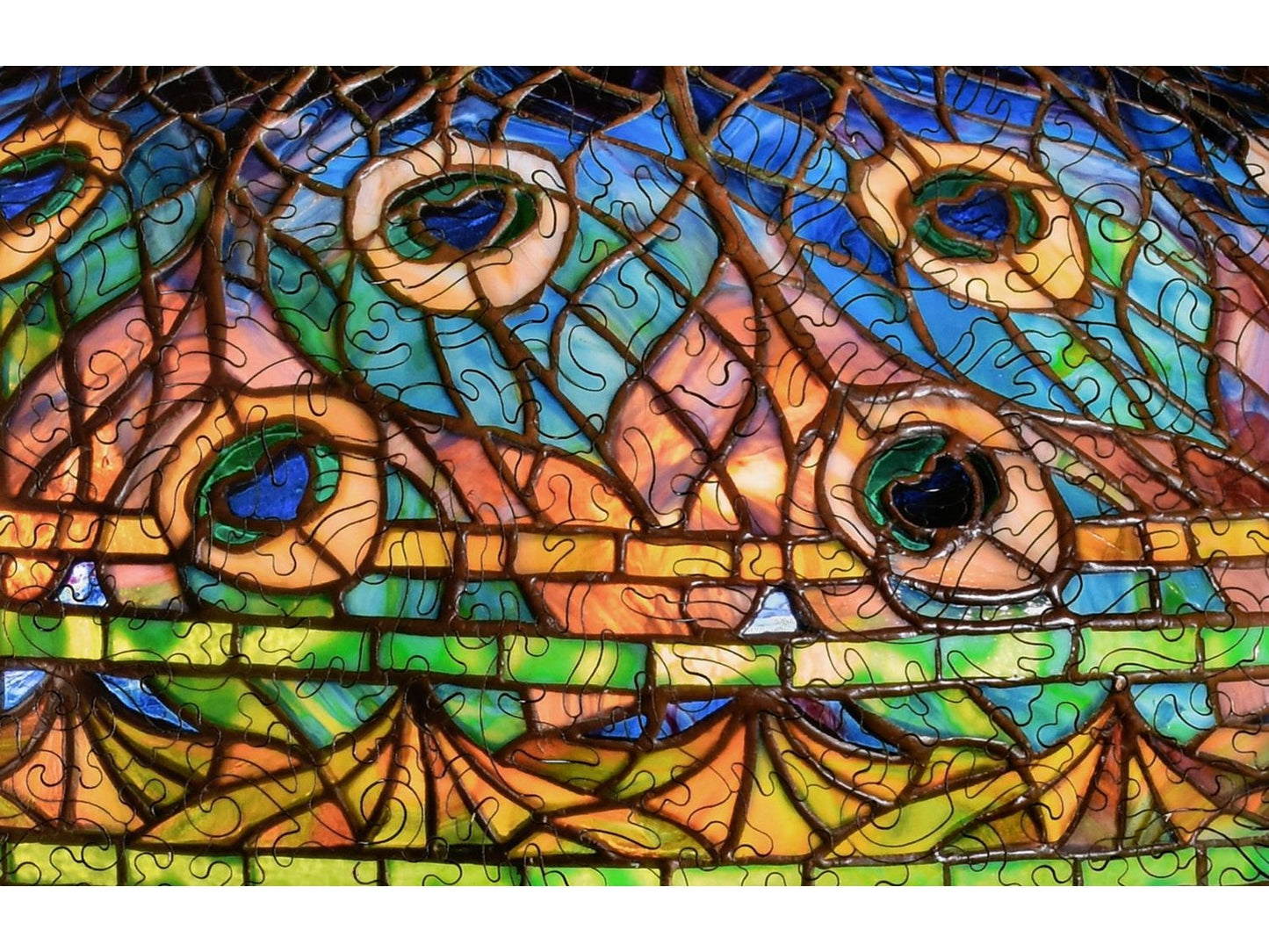 A closeup of the front of the puzzle, Peacock Library Lamp, showing the detail in the pieces.