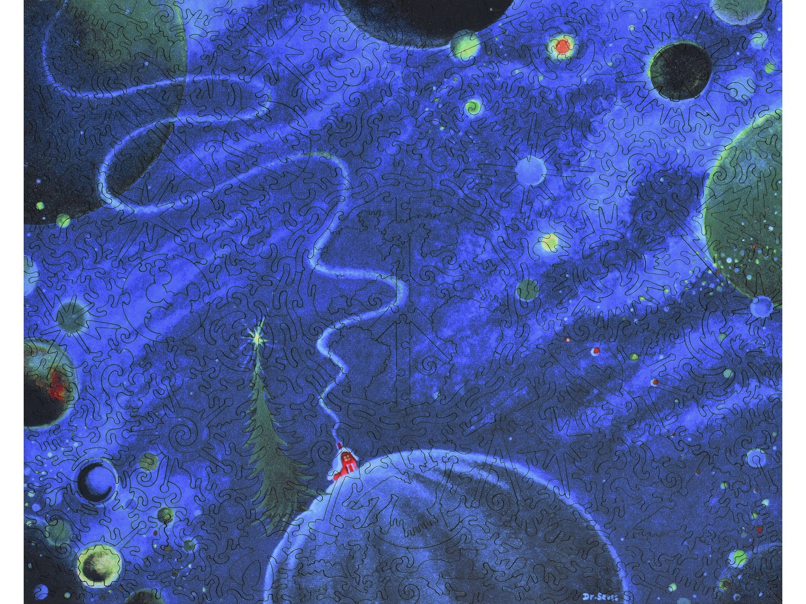 The front of the puzzle, Prayer for a Child by Dr. Seuss, with a cabin and planets in space.