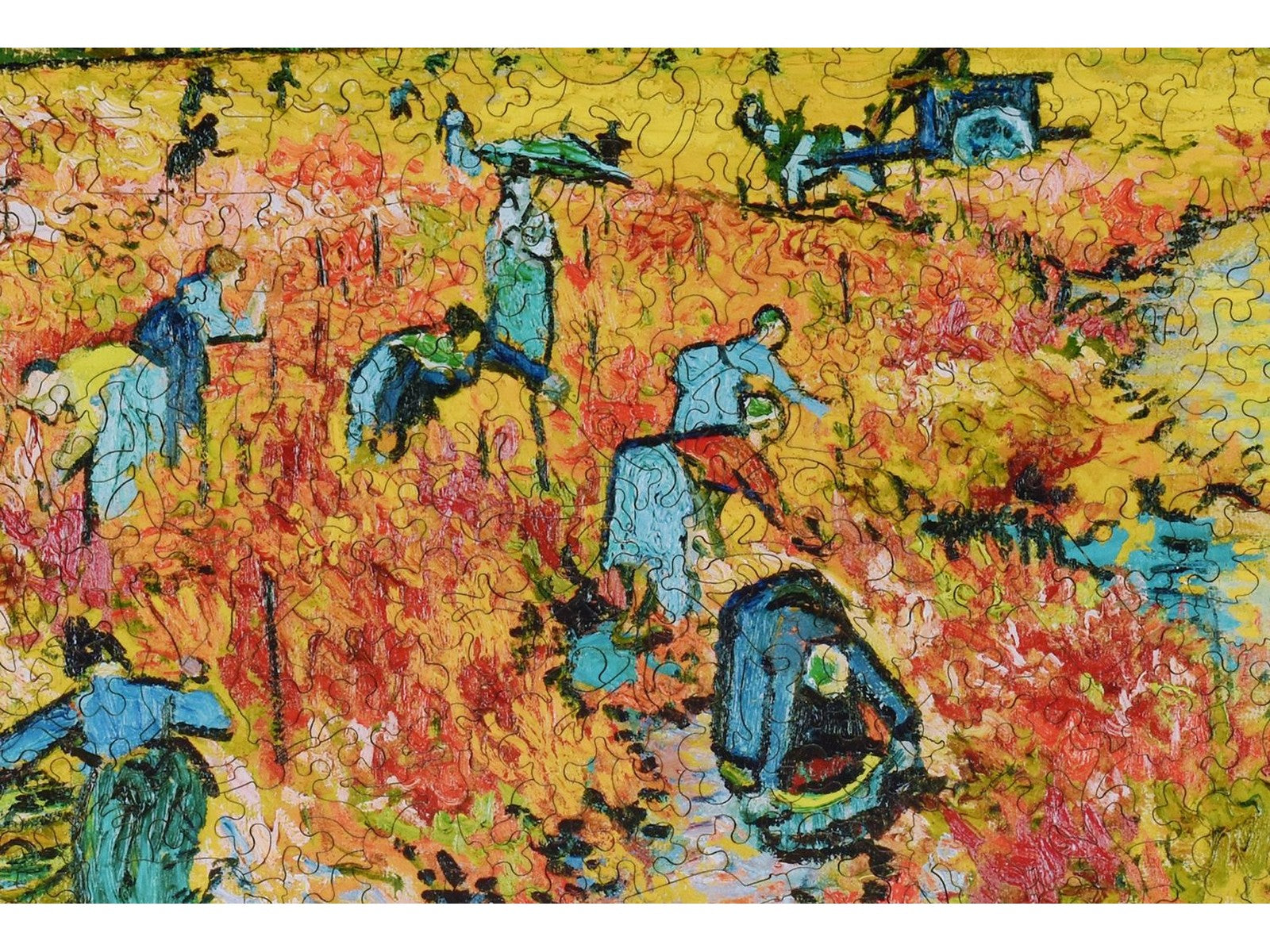 A closeup of the front of the puzzle, Red Vineyard at Arles, showing the detail in the pieces.