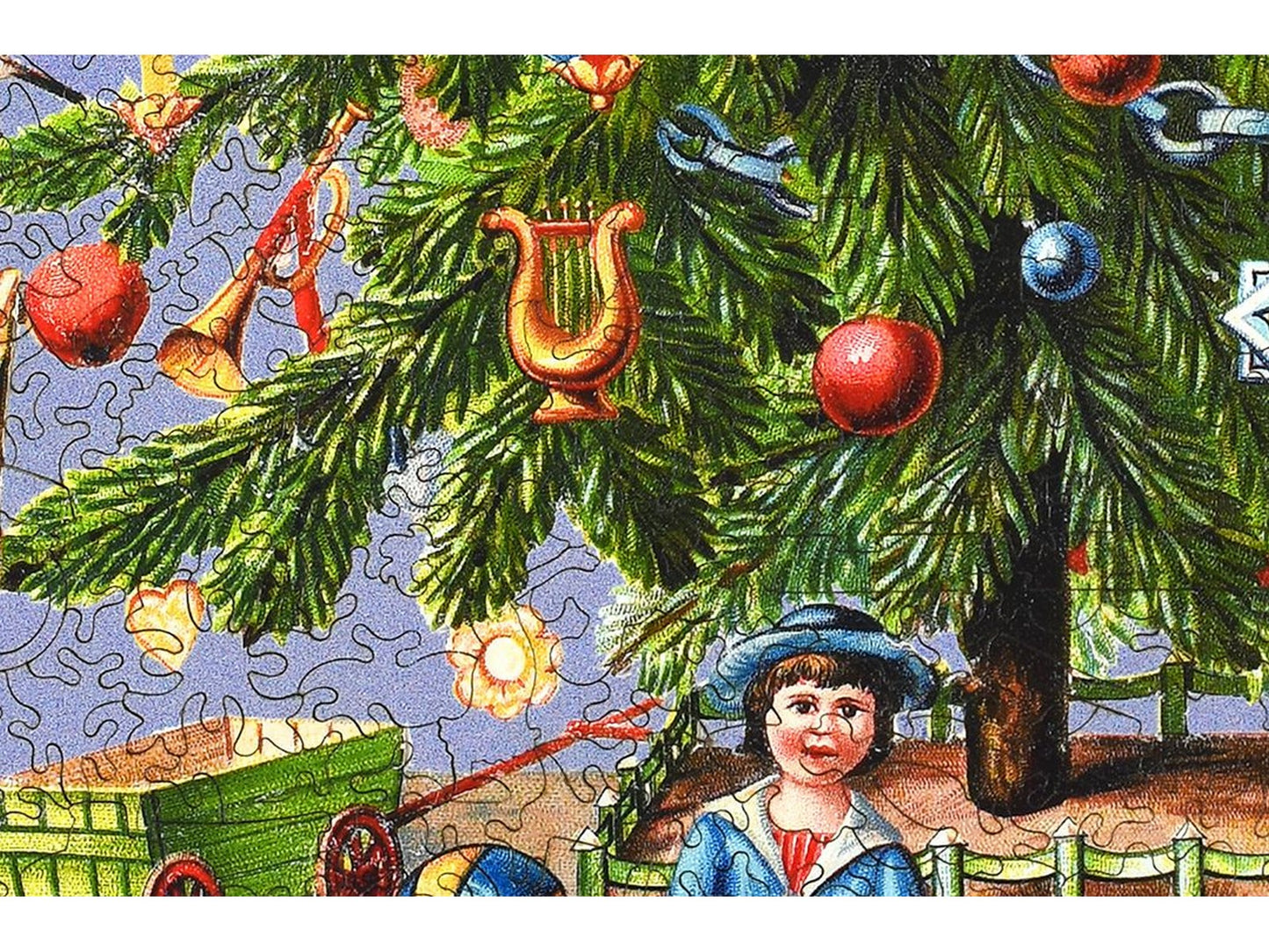 A closeup of the front of the puzzle, Victorian Christmas Tree, showing the detail in the pieces.