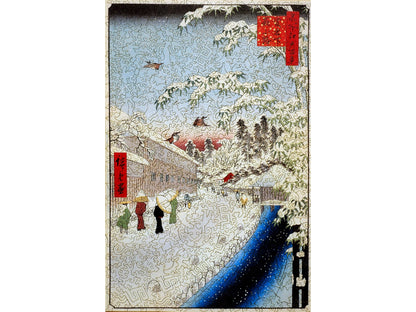 The front of the puzzle, Atagoshita and Yabu Lane, which shows several people walking next to a river in winter.