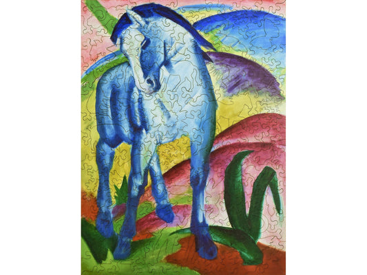 The front of the puzzle, Blue Horse I, which shows a blue horse and colorful hills.