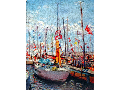 The front of the puzzle, Boats by Lindsey, which shows an impressionist style painting of sailboats in a marina. 