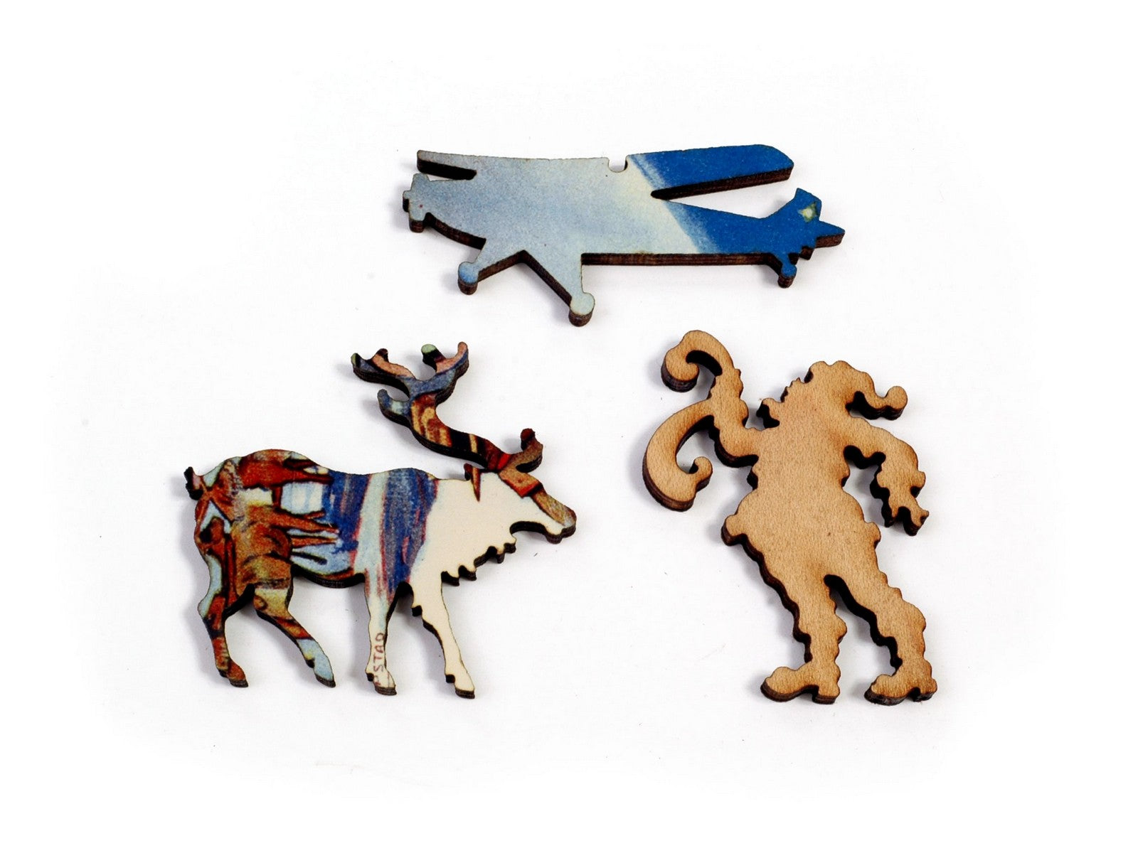 A closeup of some pieces in the shape of santa, a reindeer, and an airplane.