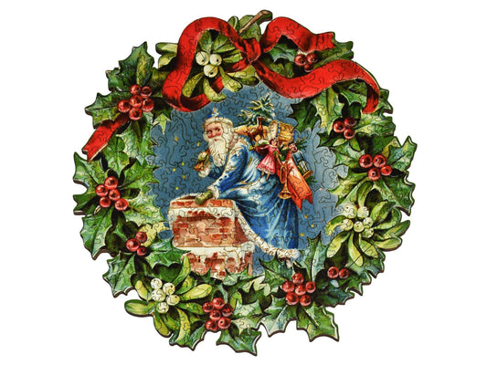 The front of the puzzle, Christmas Wreath, which shows Santa Claus climbing into a chimney, surrounded by a decorative border made of holly and ribbons.