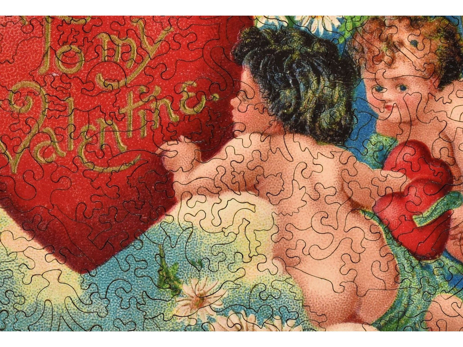 A closeup of the front of the puzzle, Cupid Garden Party.