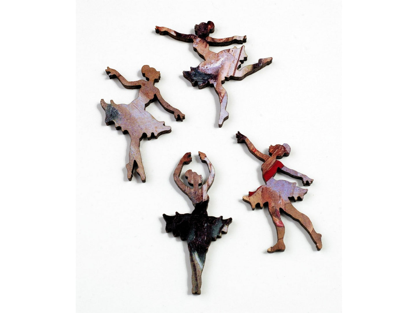 A closeup of some whimsy pieces, picturing four ballerinas. 