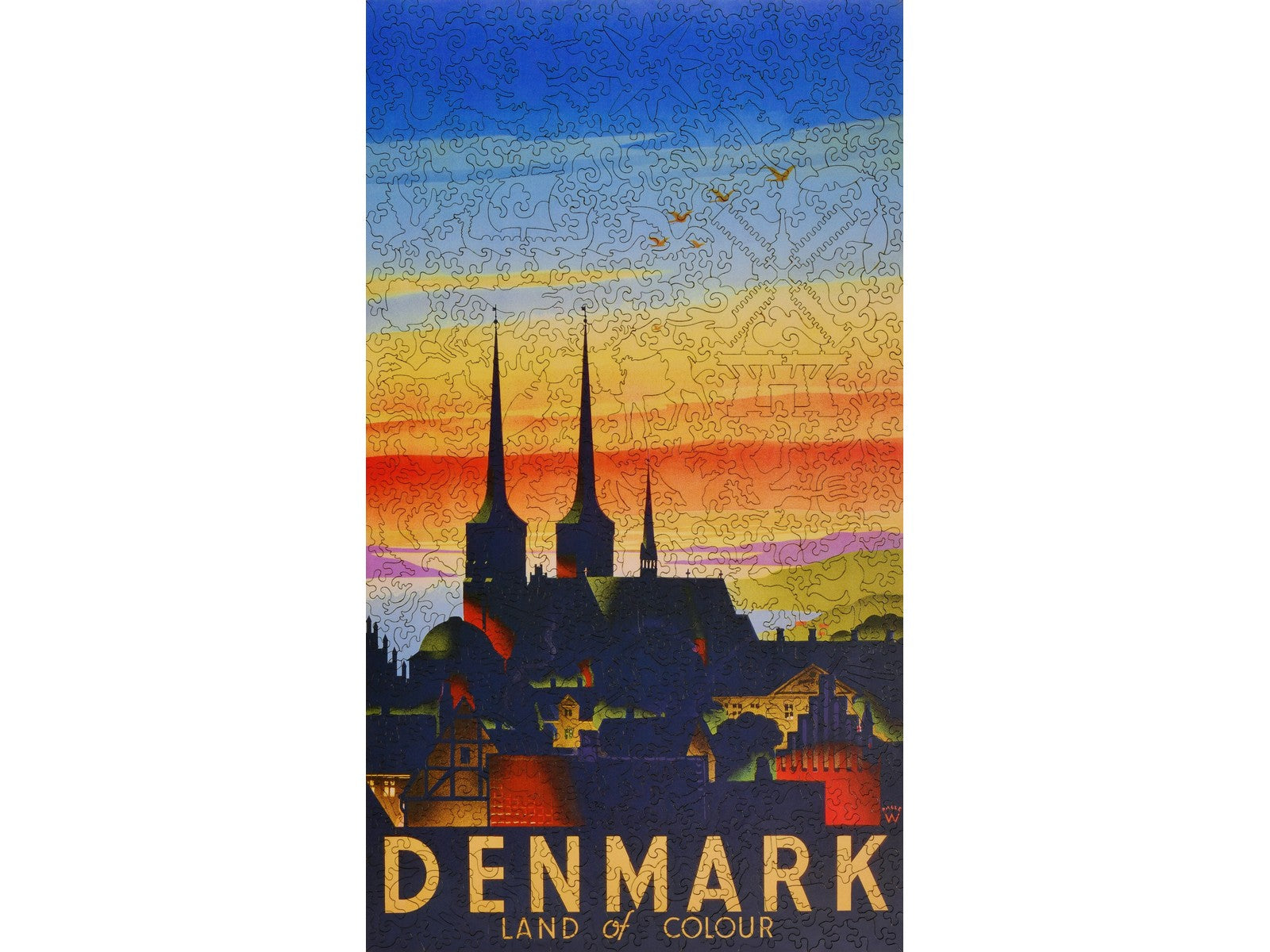 The front of the puzzle, Denmark Land of Colour, which shows a city silhouetted by a colorful sky.