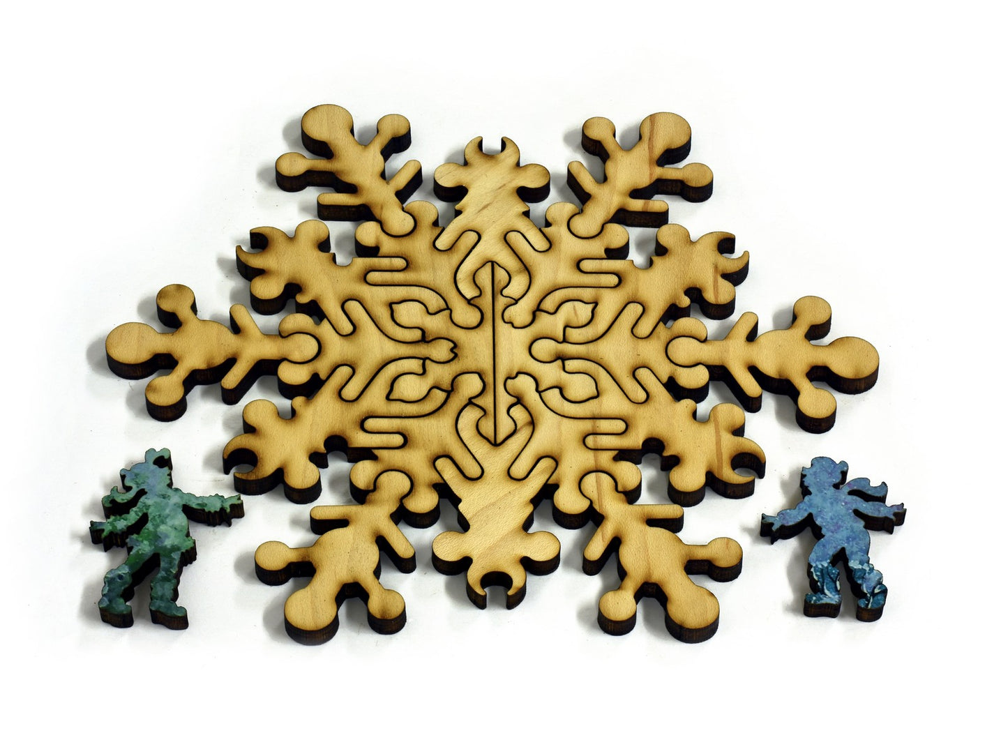 A closeup of pieces in the shape of a large snowflake and two people.