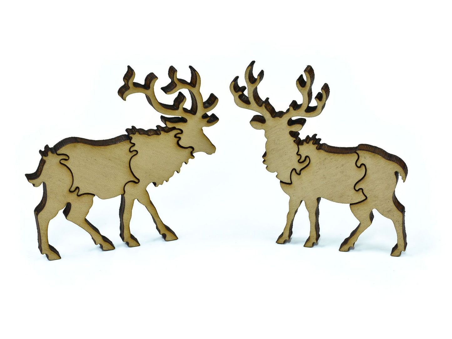 A closeup of pieces in the shape of two deer.