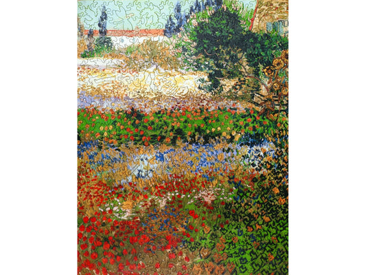 The front of the puzzle, Flowering Garden, which shows an impressionist style painting of a multi colored garden.
