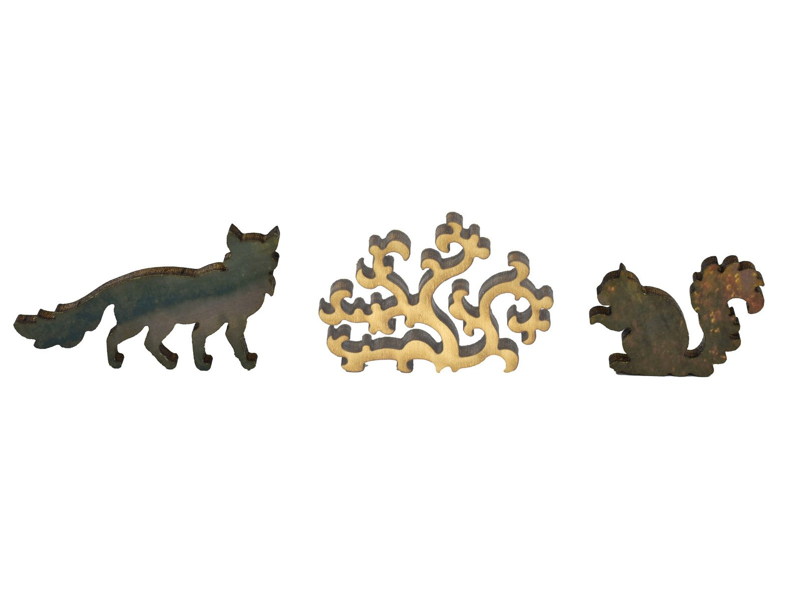 A closeup of pieces in the shape of animals and a bush.