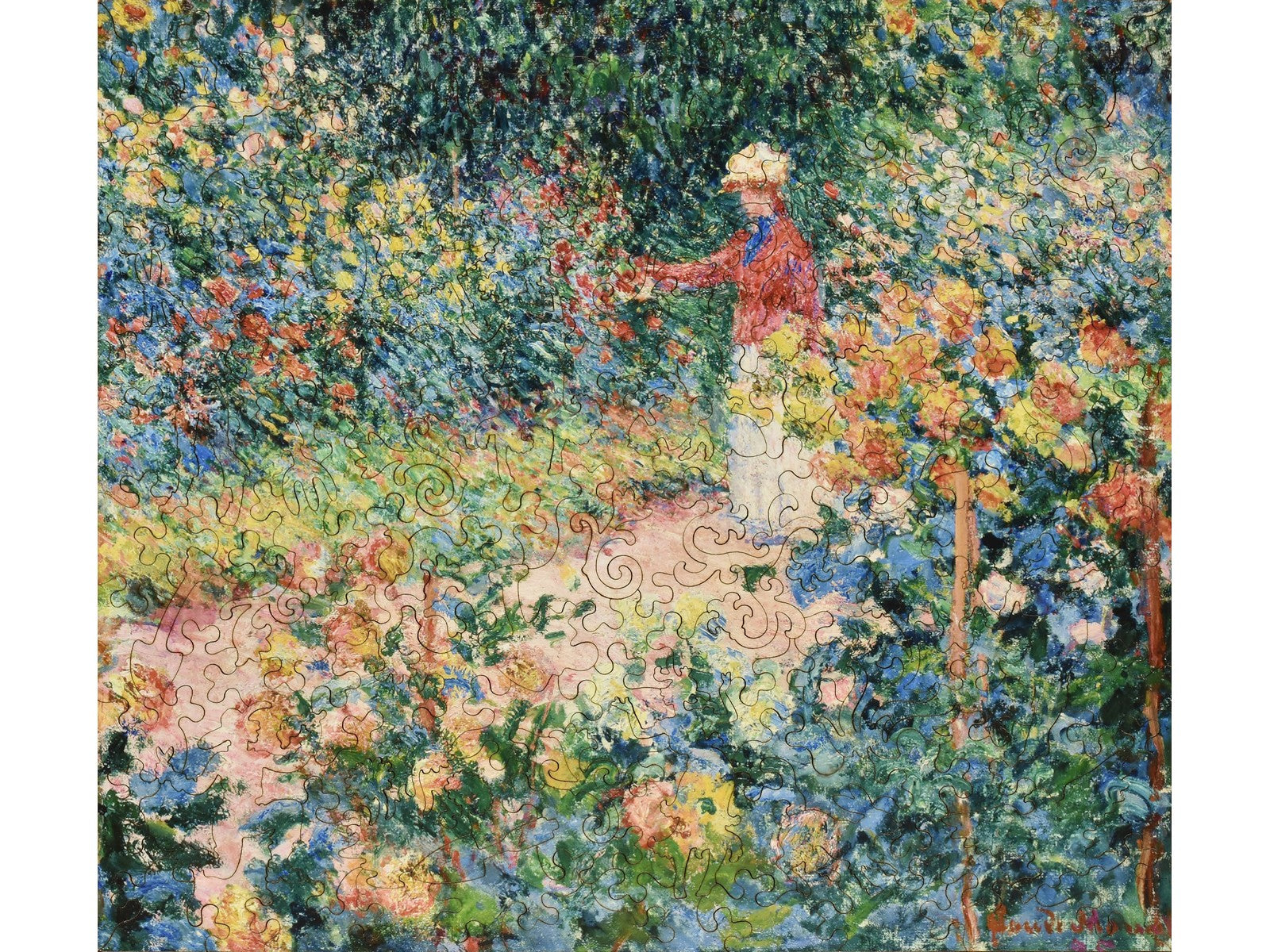 The front of the puzzle, Garden at Giverny, which shows a person walking in a colorful garden.