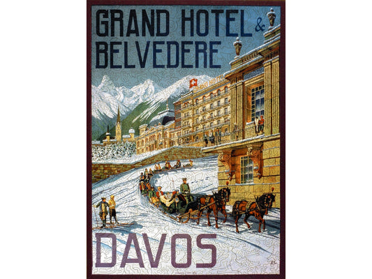 The front of the puzzle, Grand Hotel Belvedere, which shows a large hotel in the snowy mountains, surrounded by people skiing and a horse drawn sleigh. 