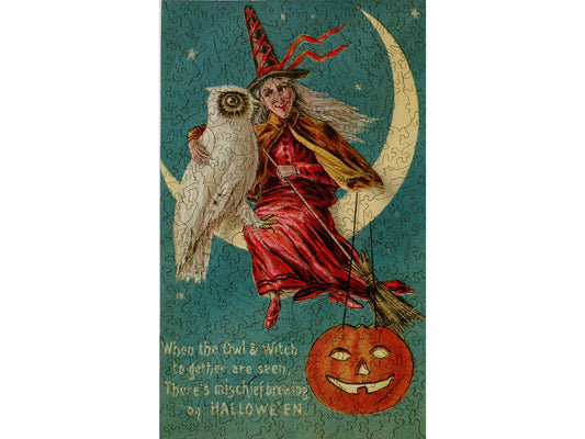 The front of the puzzle, Halloween Mischief, which shows a witch sitting a crescent moon with an owl.
