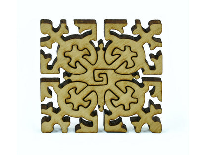 A closeup of pieces in the shape of an ornamental square.