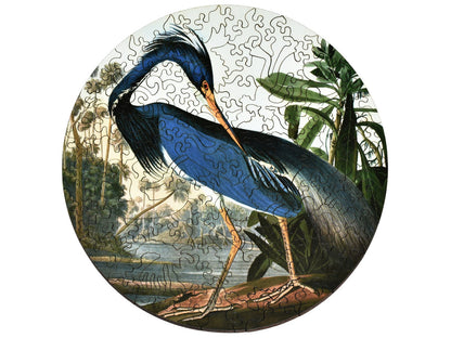 The front of the puzzle, Louisiana Heron, which shows a blue heron standing in a swamp.