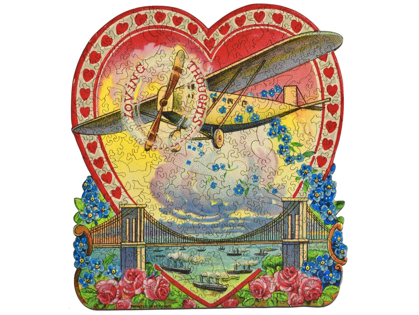 The front of the puzzle, Loving Thoughts, which shows an airplane flying over a bridge, and the words, "loving thoughts".