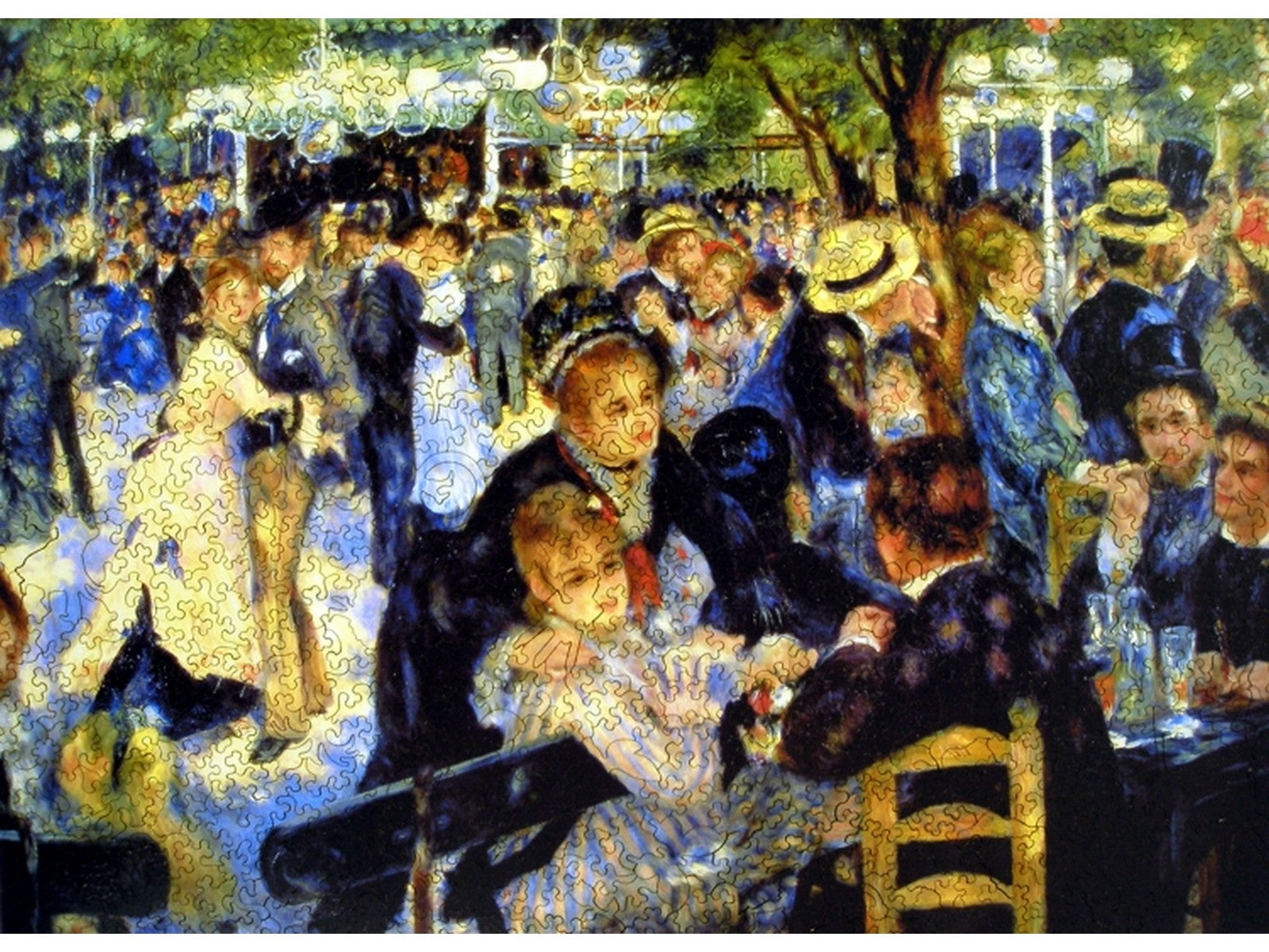 The front of the puzzle, Le Moulin de la Galette, which shows an outdoor party with people dancing.