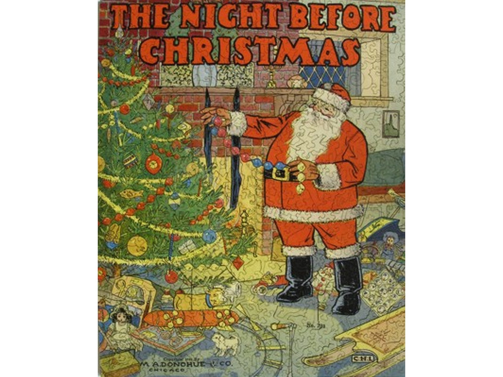 The front of the puzzle, The Night Before Christmas, which shows santa claus decorating a christmas tree. 
