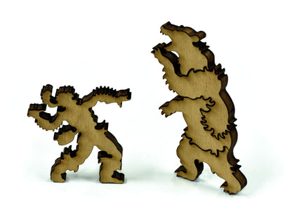 A closeup of pieces showing a mountain man fighting a bear.