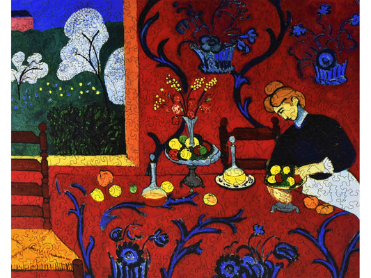 The front of the puzzle, Red Room, which shows a woman at a red table, in a red room.