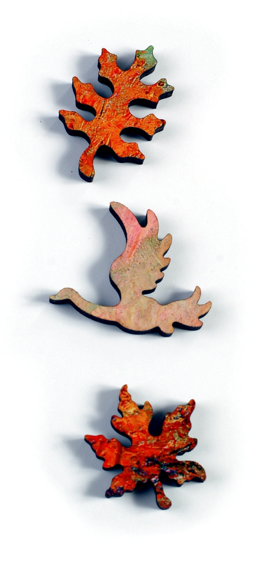 A closeup of pieces showing a bird and two leaves.
