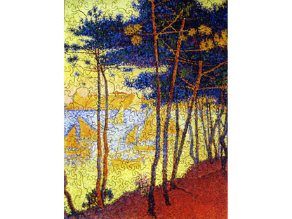 The front of the puzzle, Sails and Pine Trees, which shows pine trees growing on the edge of a lake, and sailboats out in the water.
