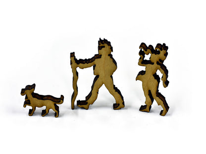 A closeup of pieces in the shape of people and a dog walking.