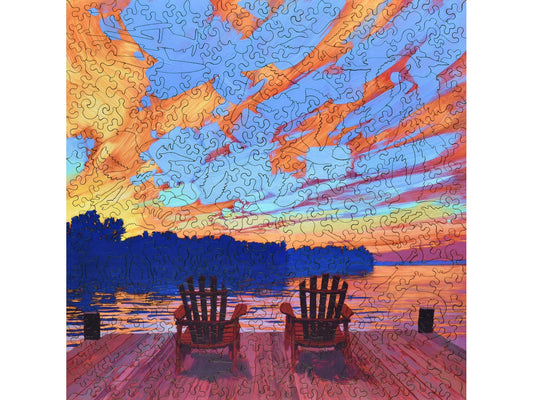 The front of the puzzle, Two Red Chairs, with a scene overlooking a lake.