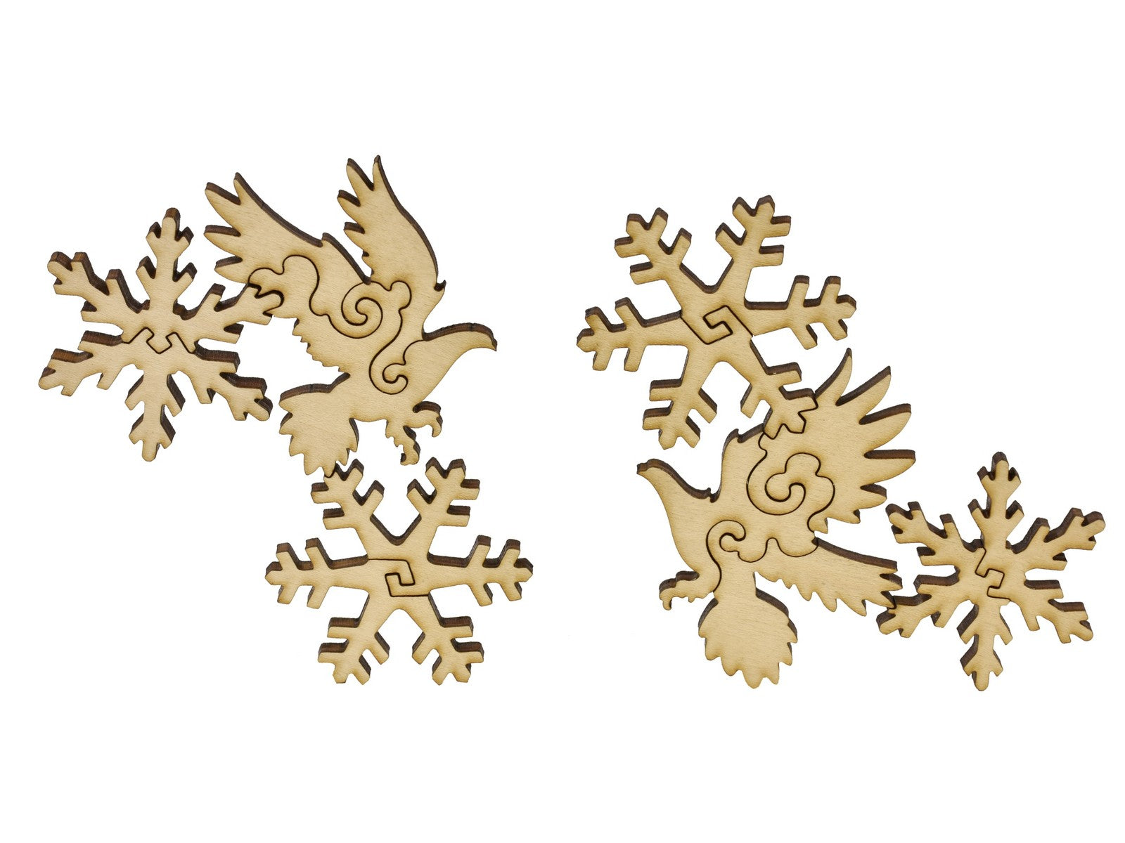 A closeup of pieces in the shape of birds and snowflakes.