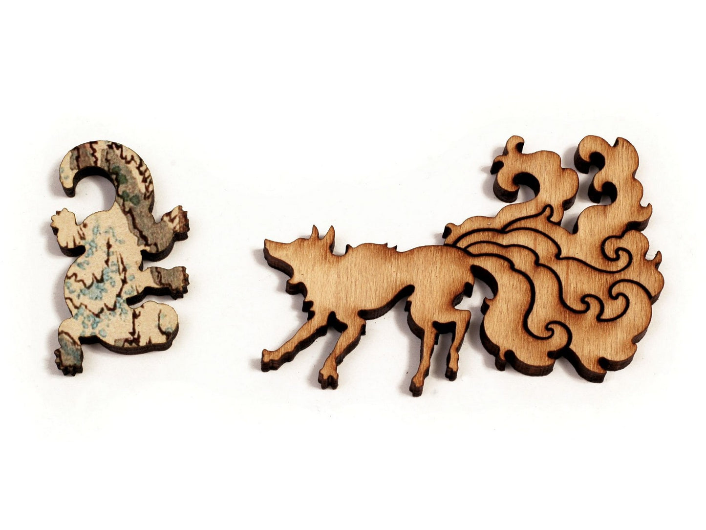 A closeup of pieces in the shape of a wolf and a lizard.