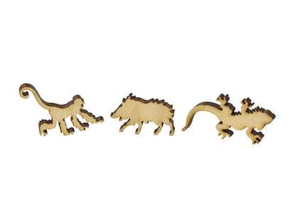 A closeup of pieces in the shape of a monkey, boar, and lizard.